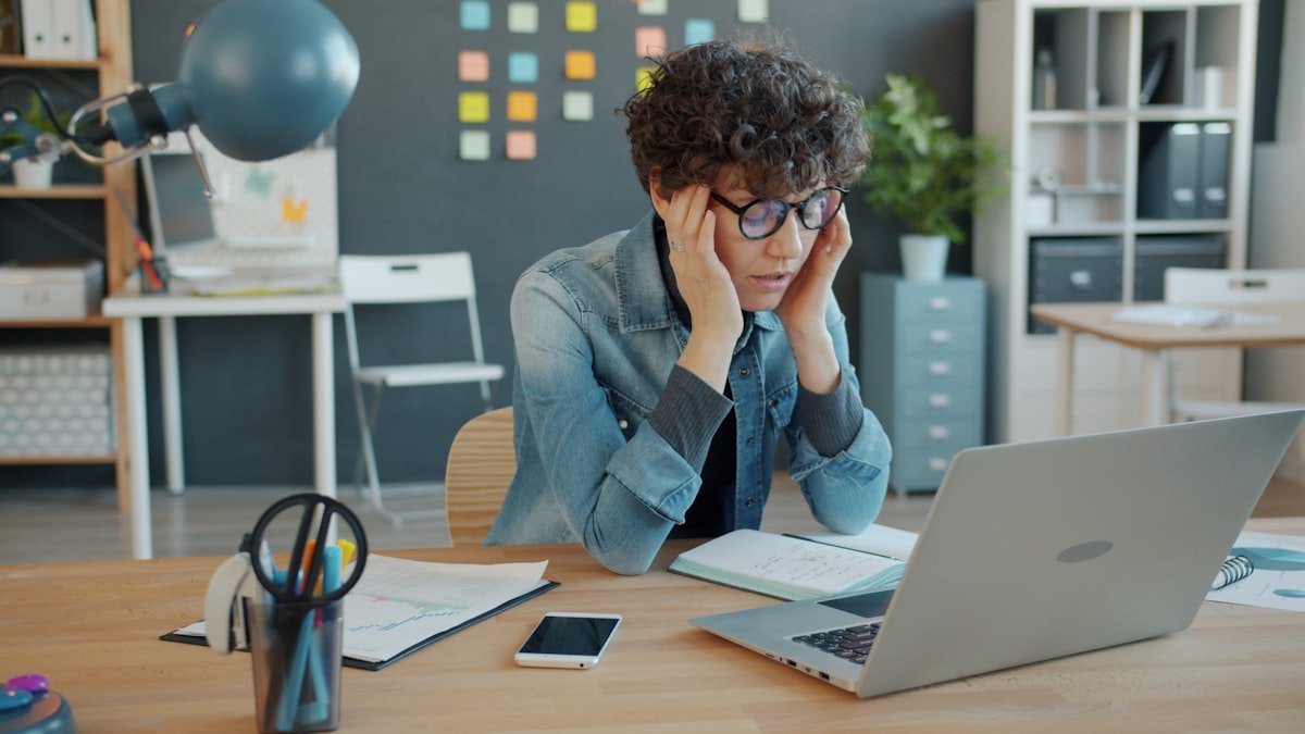 Small business owner reviewing the results of cheap web design on a laptop
