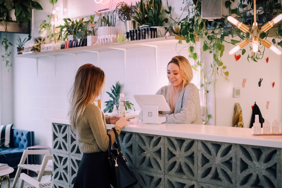 UK small business owner reviewing website builder costs against monthly invoices